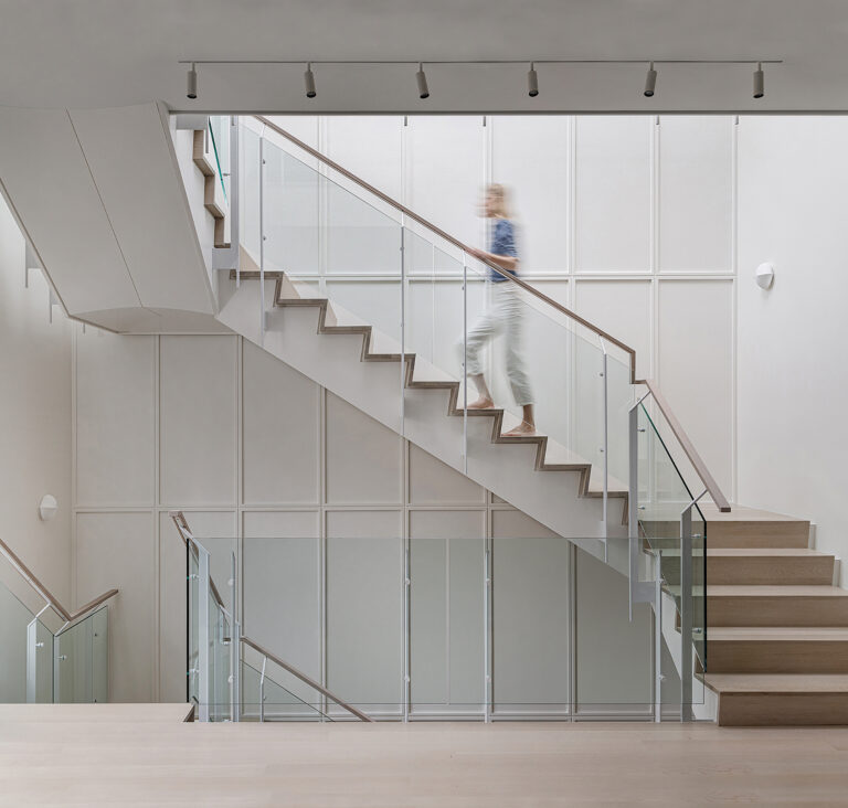 A custom stair and railing, beneath new skylights, bring light into the heart of a historic townhouse.