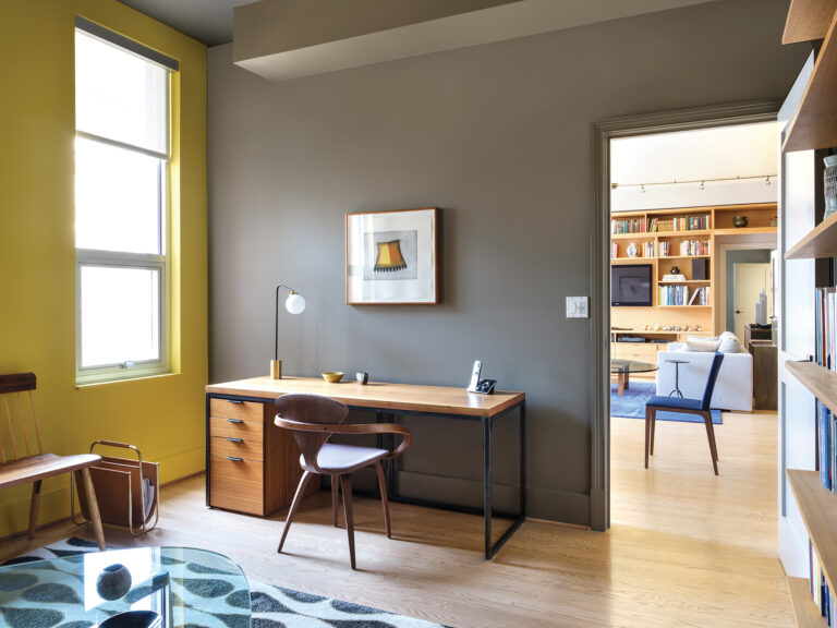 The home office of a DC condo features a custom desk and a chair by Cherner. The magazine stand was custom-designed.