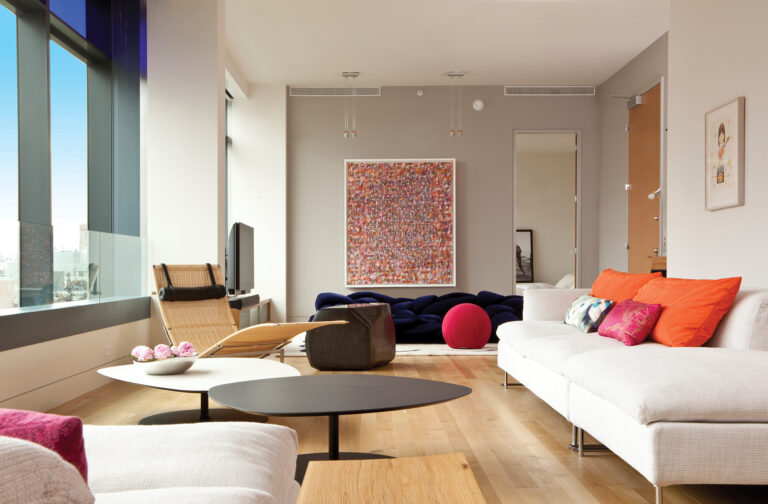 A Soho loft is furnished with a sofa and coffee tables by Moroso, paired with a Poul Kjaerholm chaise longue.