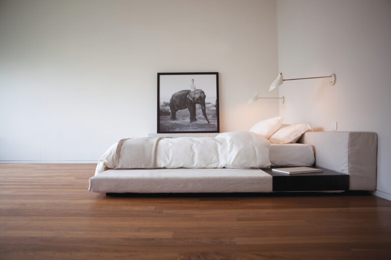 The spare and airy bedroom of a Soho condo beckons. Sconces by David Weeks.