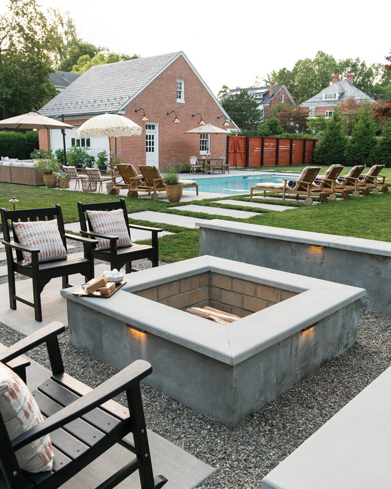 Crisp, clean lines define the fire pit area to convey a modern aesthetic, while soft pea gravel underfoot nods to Old World garden tradition.