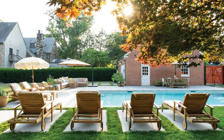 Blending clean geometry with the feel of a traditional garden path, large stone steppers delineate spots for lounge chairs beside the pool.
