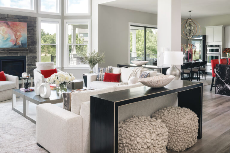 Natural light and open sightlines rule in a Davidsonville, Maryland, residence where a neutral palette of black, white and gray is enlivened by pops of red.