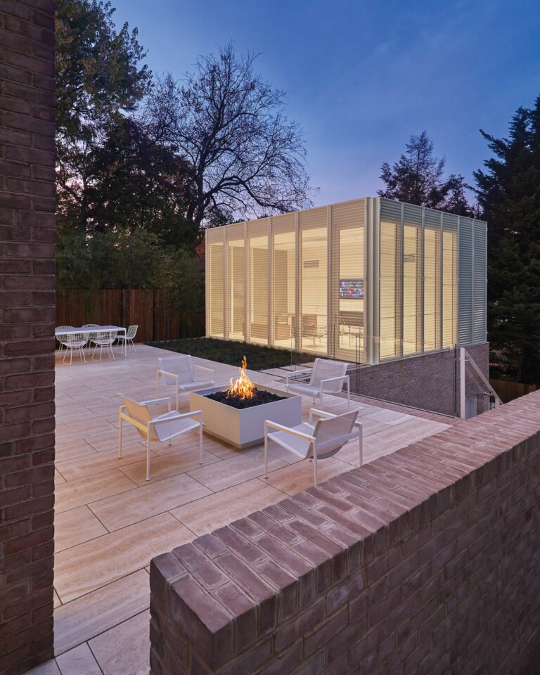 A new, two-story volume comprises a garage with an office and bathroom above it.