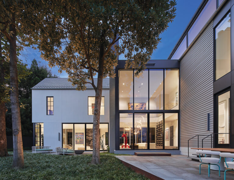 The L-shaped dwelling employs conventional materials and forms to preserve neighborhood continuity.