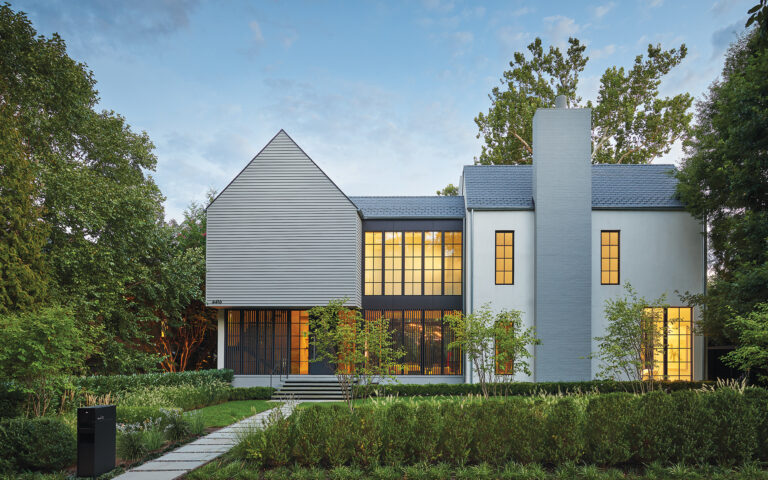 Materials including brick, stucco, slate, painted wood clapboard siding and stained mahogany respond to the home’s traditional neighborhood.