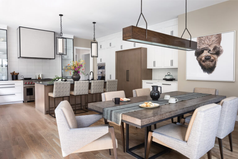 Friedman designed the kitchen in a custom Bethesda home with crisp-white cabinetry and warm wood tones. The dining table and light fixture over it are from Holly Hunt.