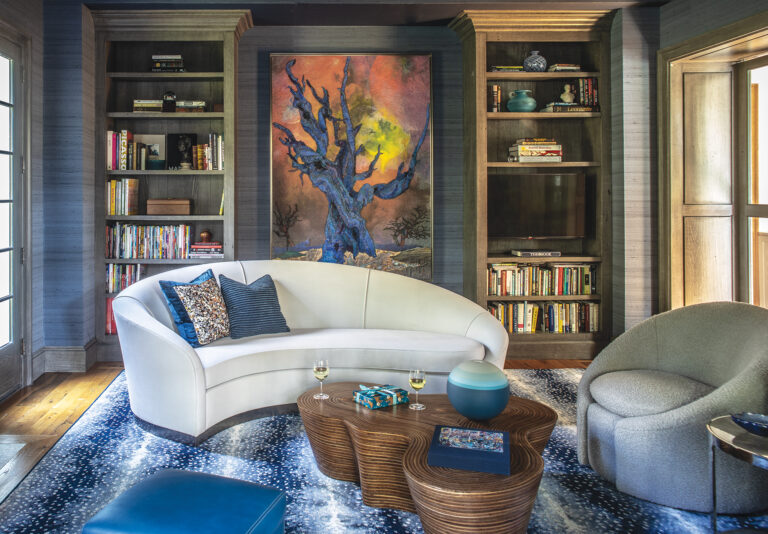 A Matthew Day Jackson canvas presides over a moody den clad in Phillip Jeffries wall covering with a Kravet sofa and a Masland rug.