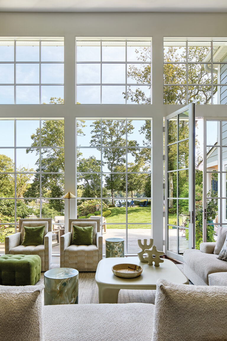 A rear view of an Annapolis waterfront renovation reveals large windows and doors overlooking the