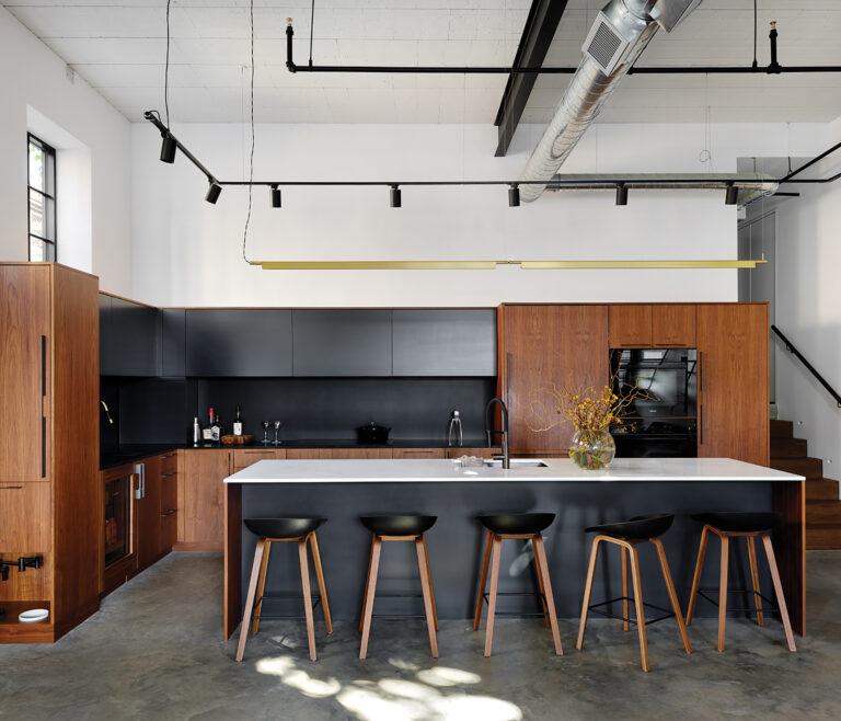 In the sleek kitchen, the architect specified a place for everything, neatly concealed in custom cabinetry by Ferris LLC.