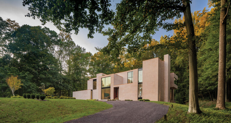 A dated Potomac McMansion (inset) got a dramatic facelift that included a new roofscape of clerestory light monitors and a re-envisioned façade of Moroccan plaster.