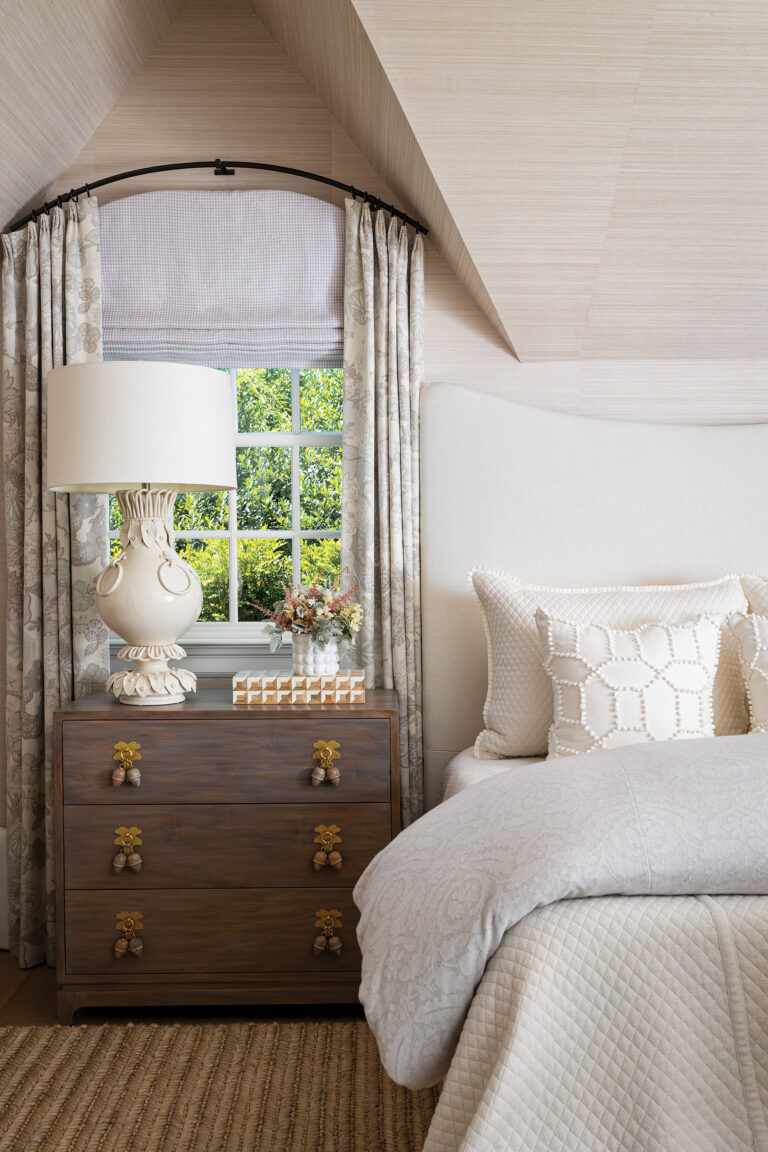 A bed layered with textured fabrics anchors a bedroom with one-of-a-kind details and loads of natural light.
