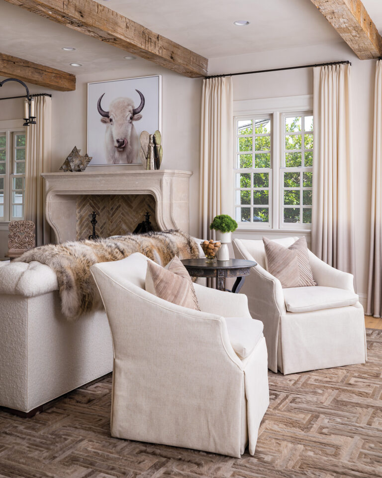 A serene picture of a white buffalo above the mantel sounds a calming note in a neutral-toned living room that exudes peace, abundance and comfort.