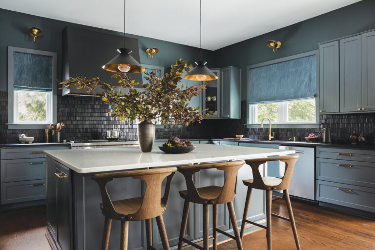 A moody palette of wood and stone-textured accents brings sophisticated warmth to an eye-catching kitchen.