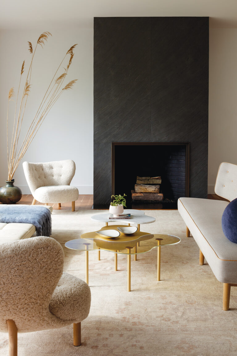 A living room of an Eastern Shore abode showcases Danish Modern furnishings including Petra chairs and a Radiohus sofa; cocktail tables are from NEO/CRAFT.