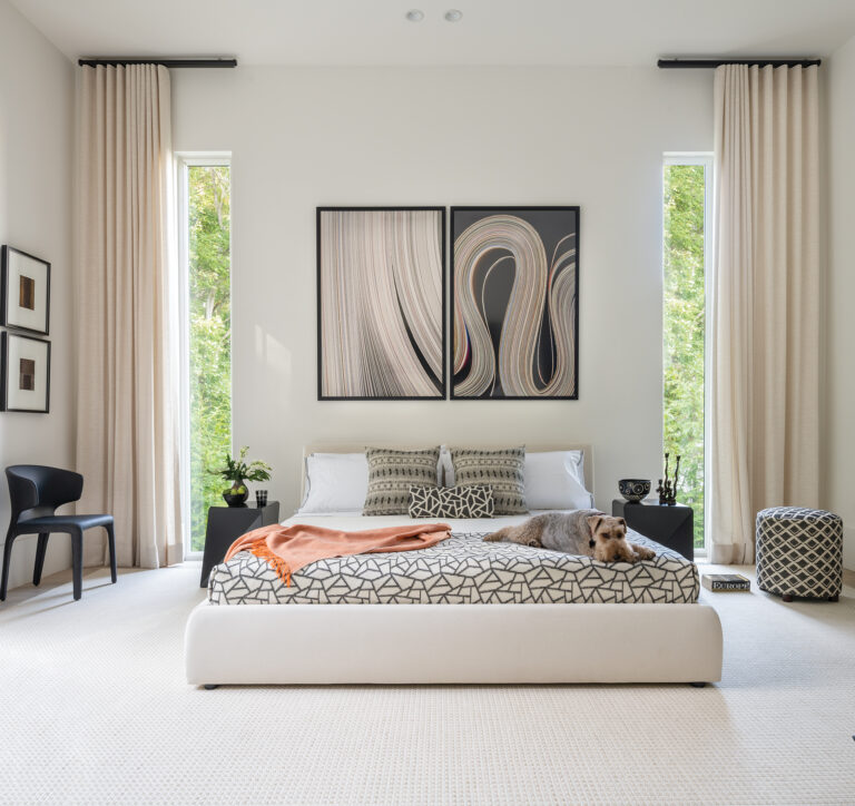 Art by John Cole animates a tranquil bedroom where Drysdale designed the custom side tables.