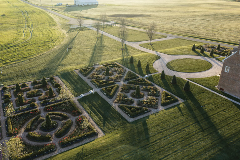A restored colonial landscape set within working farmland reveals its 18th-century form through meticulously reestablished parterre gardens. Installed and continuously maintained by McHale Landscape Design, the formal geometry anchors the historic residence in a setting that feels both timeless and alive.