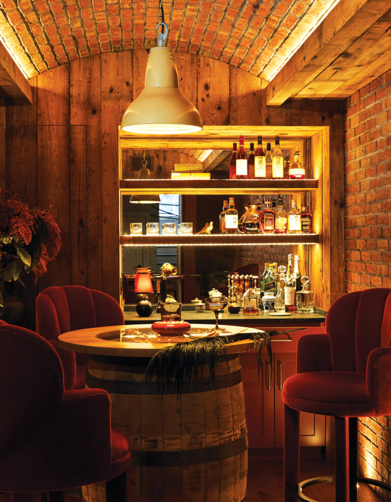 The cozy speakeasy room, outfitted with handmade bricks, antique beams and candle-lit niches, imparts a warm, historic feel.