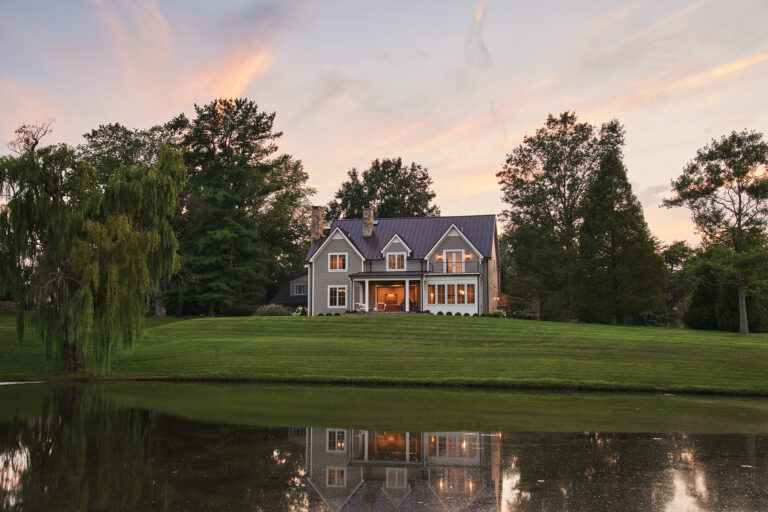 A custom home in Middleburg was sited to maximize views of a scenic pond; a Pella four-panel slider opens to the terrace.