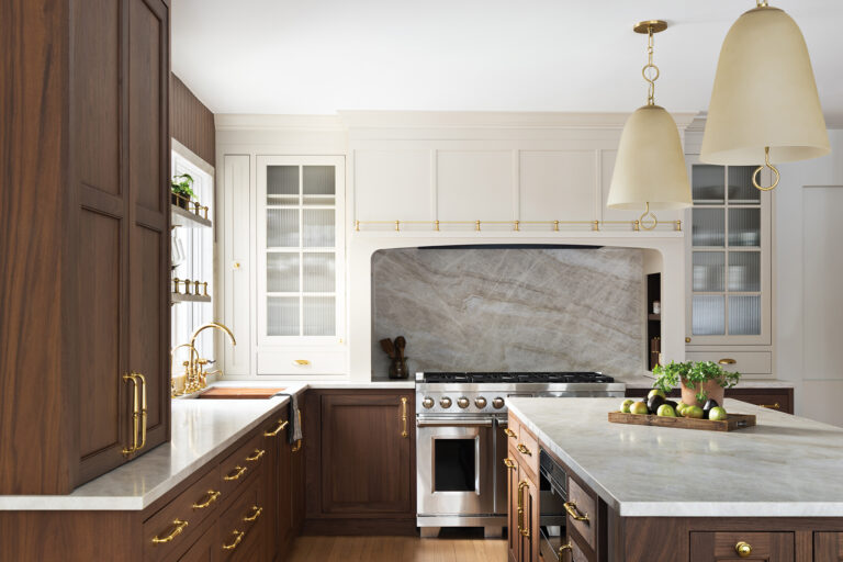 Taj Mahal quartzite surfaces and a mix of warm walnut and cream-colored cabinetry conjure refinement in a Bethesda kitchen.