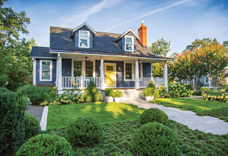 Geometric forms define a bungalow’s landscape with a concrete band around the lawn and boxwoods set in dwarf mondo grass.