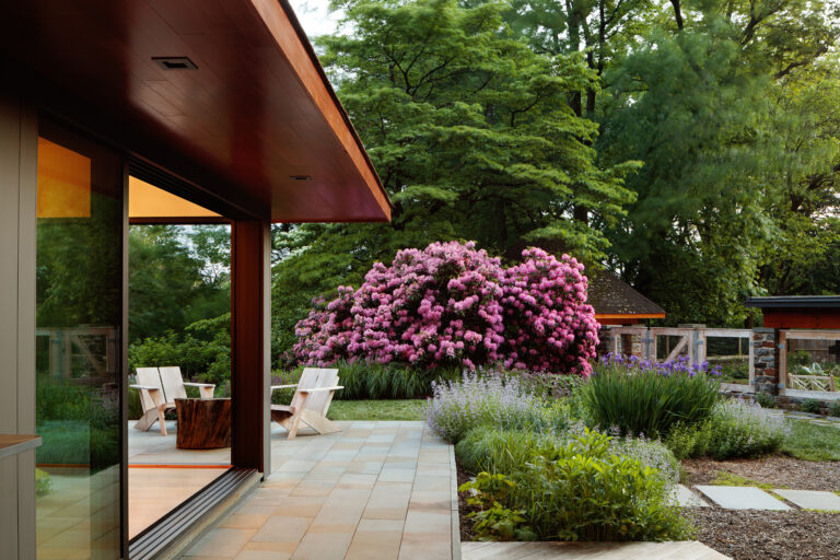 Designed as a series of interconnected garden rooms, the landscape responds to the home's architecture while naturalistic plantings soften the edges, creating a seamless transition between house and garden.