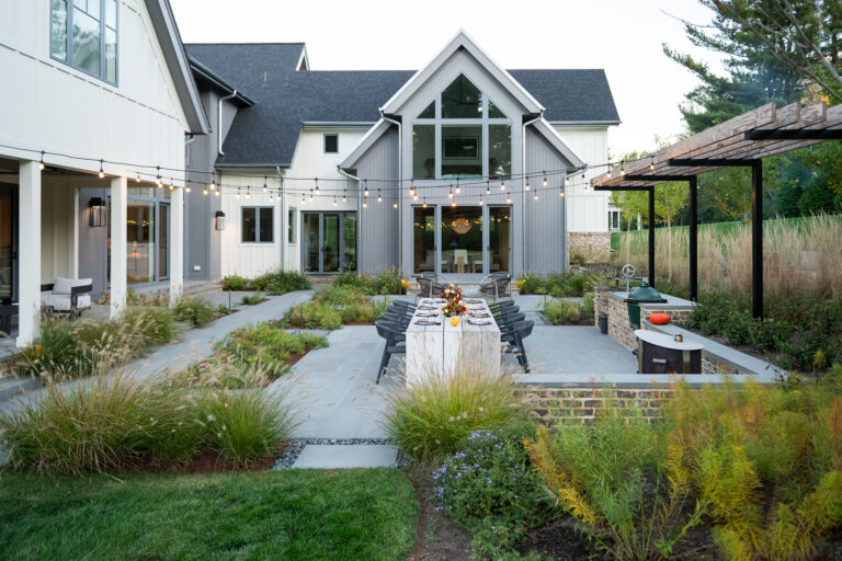 Anchor PicturesWarm lighting, layered plantings, and generous seating areas create an inviting outdoor environment that comes alive long after sunset.
