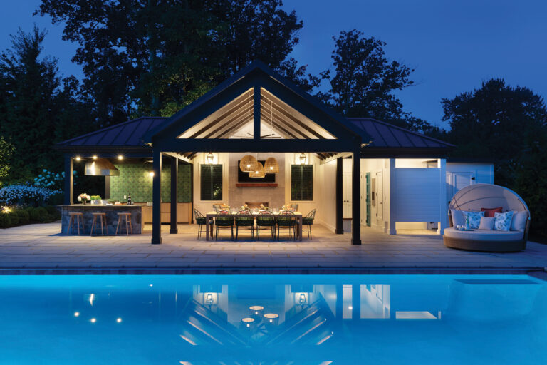 A sleek pool pavilion features a kitchen, outdoor shower and temperature-controlled bathroom.