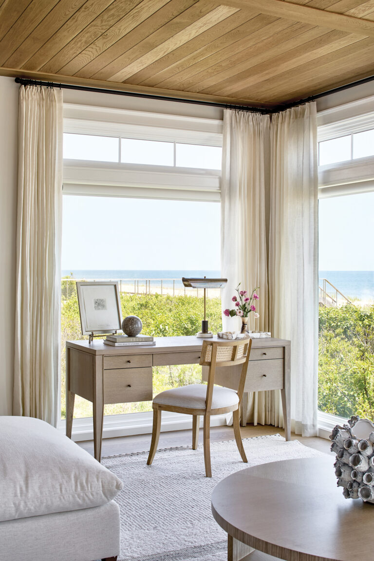 Ocean views take center stage in a Bethany Beach bedroom with white oak ceiling details and linen panels.